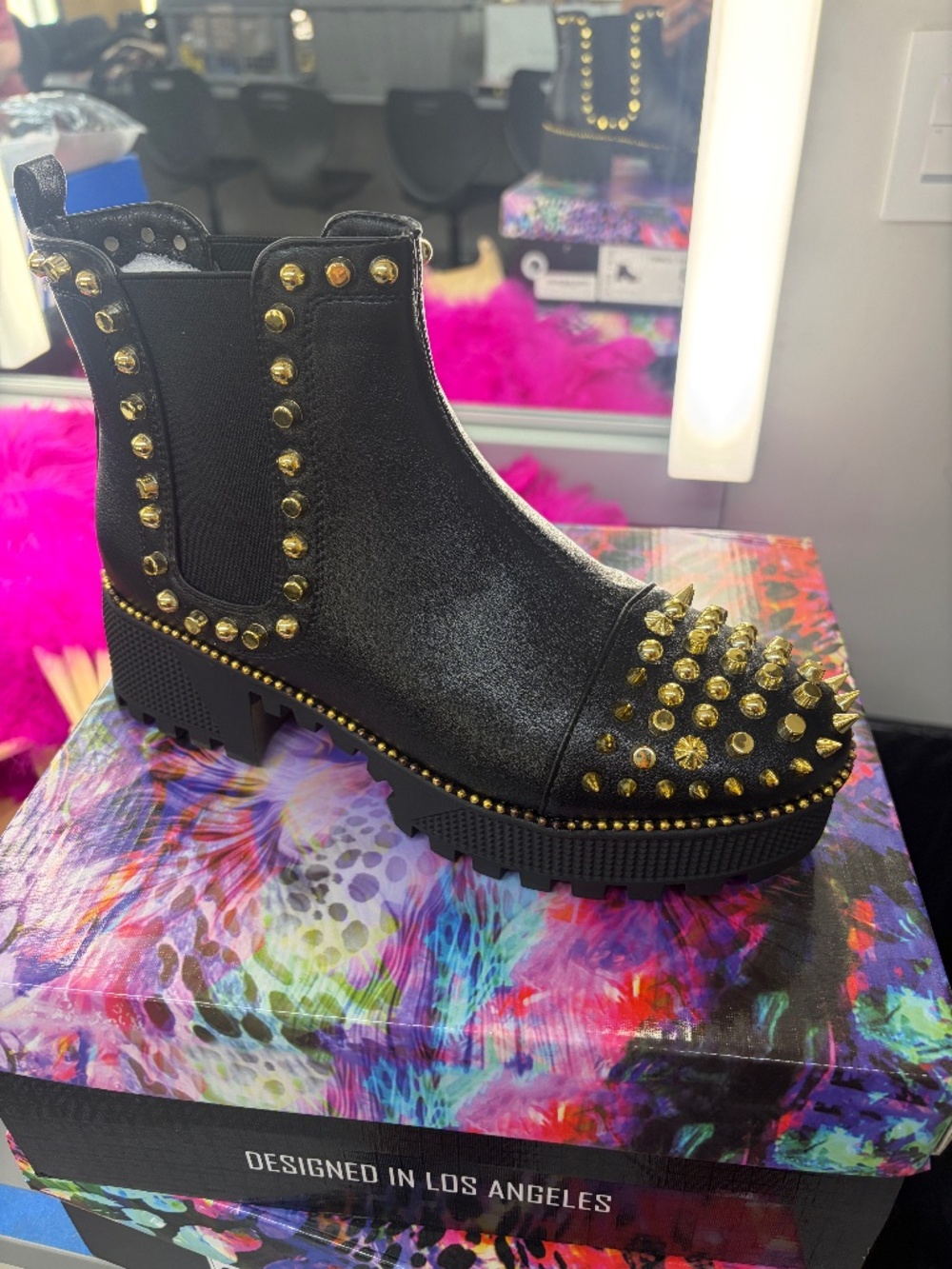 Black ankle boots with gold spikes